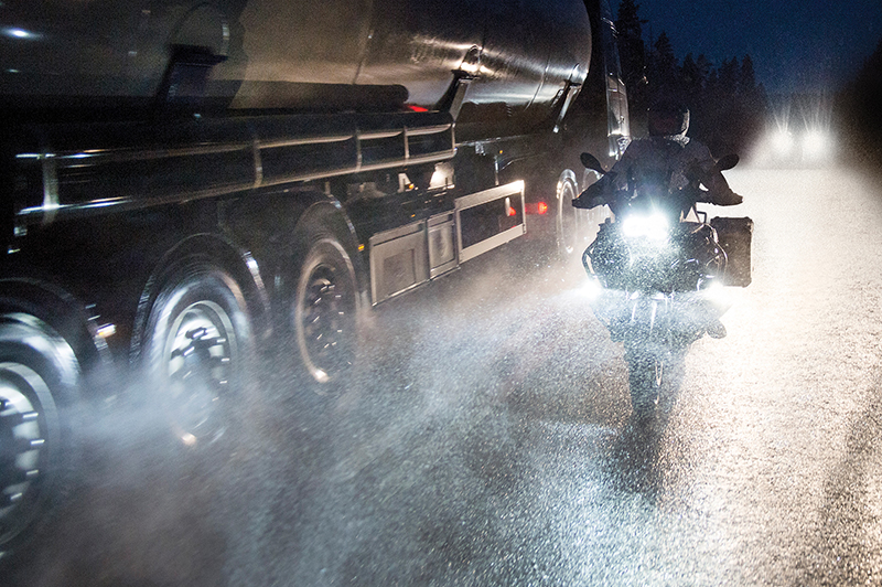 Guy riding at night in foul weather